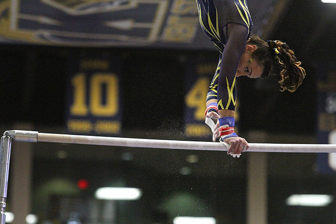 Kent States Rebecca Osmer competes on the uneven bars during the meeting against Ball State University on Sunday, March, 8, 2015. Rebecca Osmer finished her routine with a 9.875. The Flashes won 196.800-195.50.