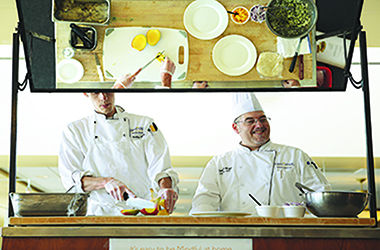 Chefs Andrew Eith and Timothy Wright prepare grilled fish tacos with mango slaw for a food demonstration introducing Kent States new mindful menu items. Photo courtesy of Kent State Dining Services.