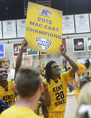 Kent State sophomore forward Marquiez Lawrence holds celebrates with teamates after the Kent Beat Akron 79-77 to win the MAC East in the M.A.C. Center on Friday, March 6, 2015. Senior guard Kris Brewer scored a layup with one second left in the game and chaos ensued as the bench and crowd rushed the court in celebration.