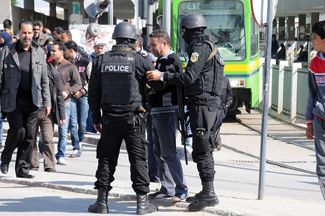 Police secure the area outside the National Bardo Museum in Tunis, Tunisia, near the Tunisian Parliament building, where two gunmen were killed after an attack at the museum killed 19 people on Wednesday, March 18, 2015.