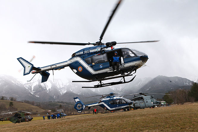 Rescue helicopters and a rescue team from the French Securite Civile fly over the French Alps during a rescue operation after the crash of an Airbus A320 near Seyne-les-Alpes, France, on Tuesday, March 24, 2015. (Julien Tack/Abaca Press/TNS)