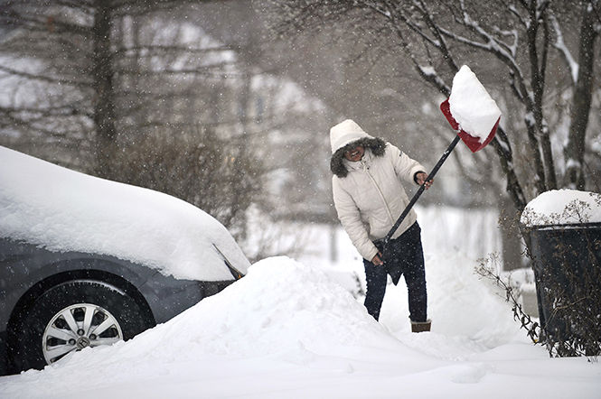 Vandana Kalia shovels snow off her driveway in the GreenTree neighborhood on Jan. 26, 2015 in State College, Pa. Heavy snow fell overnight, closing all Centre County schools. 