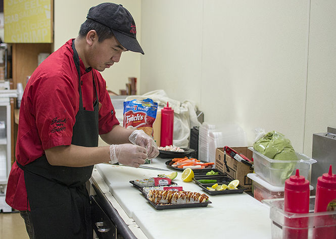 Head chef of Sushi with Gusto Andrew Nun prepares a California roll and a veggie roll. Sushi with Gusto is located in the HUB in the student center and serves fresh sushi.