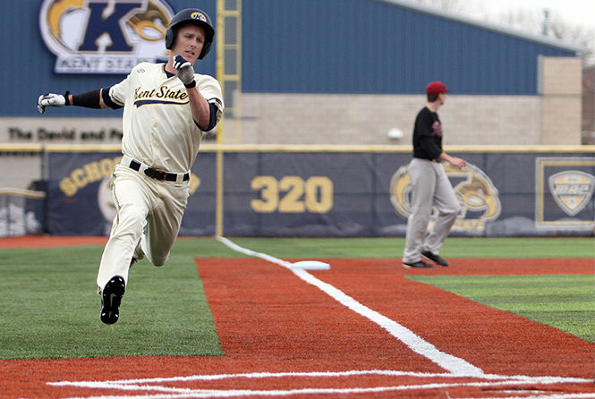 Outfielder Luke Burch sprints to home plate to score the first run during a game against Rider University at Schoonover Stadium on Friday, March 13, 2015. Kent State won 13-5.