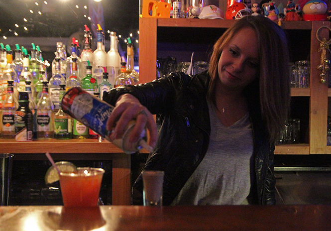 Bartender and senior finance major Madeleine Harster makes a shot at Brewhouse on Saturday April 4, 2015. Brewhouse won best place to go if you are under 21.