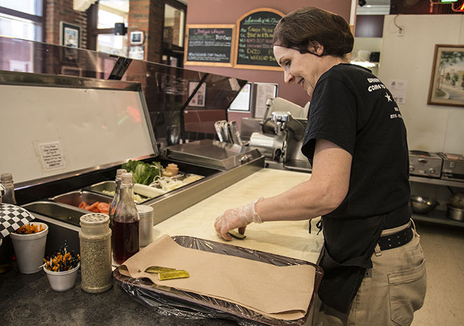 Manager Jill Wymer, prepares a sandwich platter during lunch on April 4, 2015.