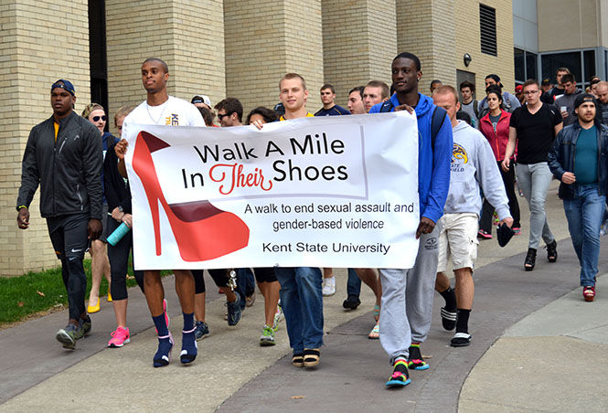 Students walk down the Esplanade in womens shoes on April 14, 2015. “Walk a Mile in Their Shoes,” raised awareness for sexual violence and rape.