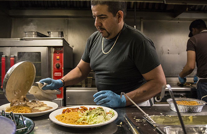Miguel Valadez prepares meals at Guaca-Moles Mexican Grill and Cantina on April 6, 2015. Guaca Moles, which has made a home for itself on Main Street over the past for nine years, is well known for their seven different kinds of fahitas.