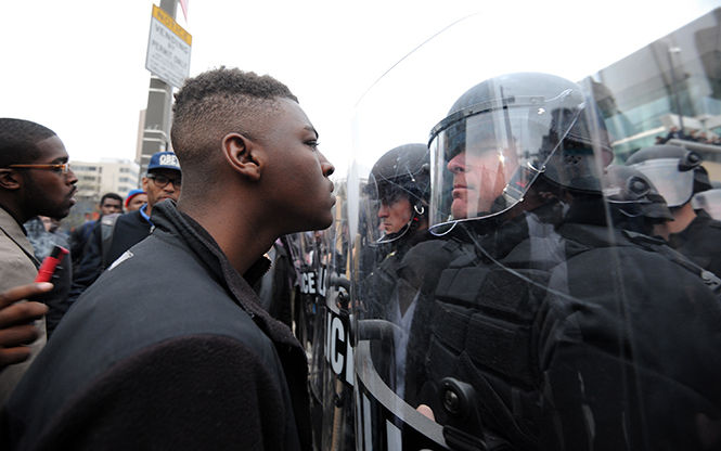 Police and protestors line up against each other across from Camden Yards in Baltimore on Saturday, April 25, 2015, as protests continue in the wake of Freddie Grays death while in police custody. (Algerina Perna/Baltimore Sun/TNS)