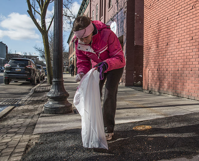 Kathryn Ranieri, a senior exercise physiology major participates in Clean up Kent on April 4, 2015. Volunteers from the local community picked up litter all around Downtown Kent as form of community service.