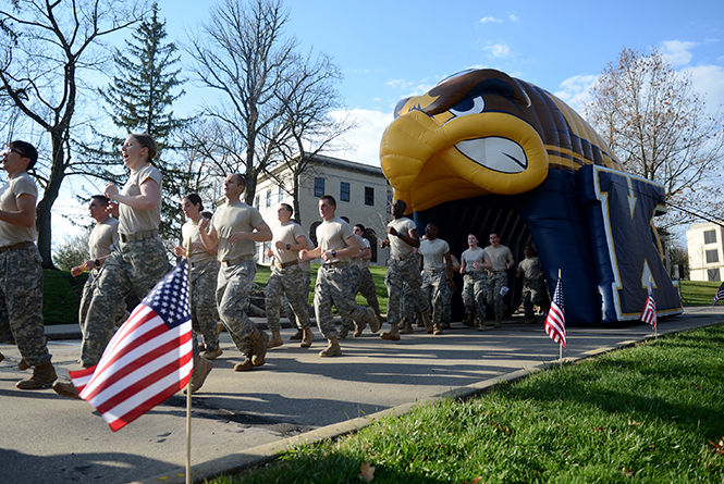 ROTC cadets approach the finish line at The WhiteHot 5K race across the Kent State campus that honors former fallen ROTC soldier Ashley White-Stumpf, who was killed in Afghanistan in October of 2011. The money raised from the race goes into a scholarship fund bearing White-Stumpfs name that benefits ROTC Cadets at Kent.