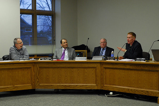 Kent City Manager David Ruller answers a question his colleague Melissa Long asks during the discussion of options for City Halls two-year, temporary relocation at the city council meeting on Wednesday, April 1, 2015.