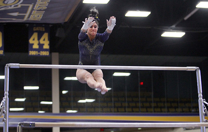 Kent+State+freshman+Michaela+Romito+looks+for+the+bar+during+her+uneven+bars+routine+on+Sunday%2C+Feb.+15%2C+2015%2C+at+the+M.A.C.+Center.+Kent+State+lost+to+Central+Michigan%2C+195.325-196.400.