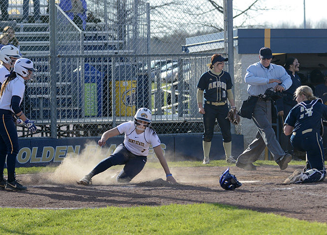  Kent State Freshman infielder Vanessa Scoarste slides into home scoring a run during their 12-2 win over the University of Akron at the Diamond at Dix on Friday, April 10, 2015. The Flashes lost the first game of the double header to Akron, but improved their record to 24-9 overall.
