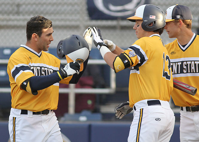 Sophomore infielder Conner Simonetti high-fives his teammates after hitting a 2-run homer to right center during Kent State’s game against Penn State at Schoonover Stadium on Tuesday, April 21, 2015. Following SImonetti’s at bat, sophomore Curtis Olvey hit another homerun, but The flashes ended up losing to the lions 15-5.