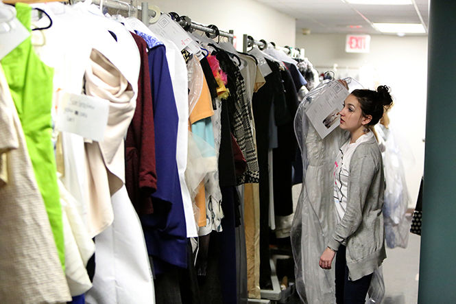 Senior Fashion Mechandising major Noelle Horan hangs clothes in preperation for the annual Kent State School of Fashion Fashion show in Rockwell Hall on Wednesday, April 22, 2015.