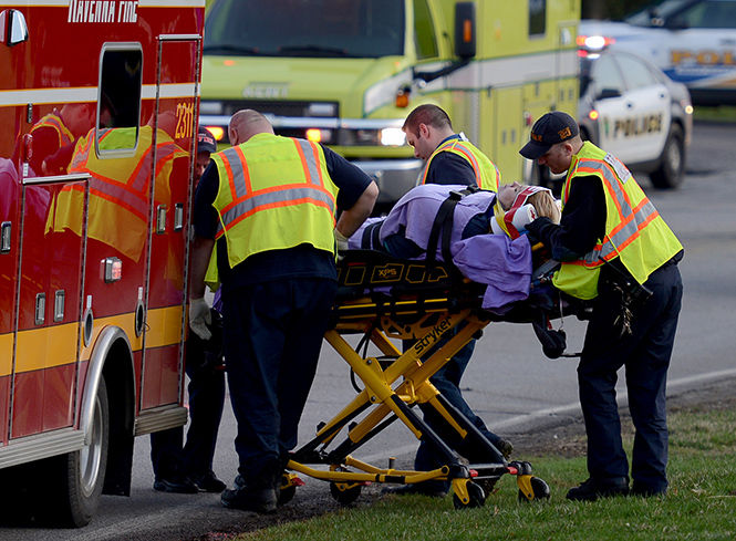 The Kent Stater A female involved in an accident on Loop Road is loaded via stretcher into an ambulance and taken to the hospital on Wednesday, April 8, 2015.