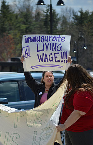 A Members of AFSCME, a workers union on campus, pickets outside the M.A.C. Center on May 1, 2015 as President Beverly Warren is inaugurated inside. Wage negotiations are currently being conducted between the university and the union.