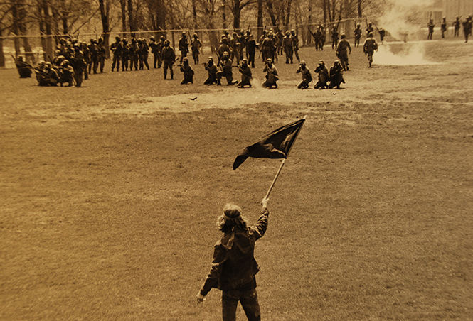 Alan Canfora waves a black flag as the National Guard takes aim on May 4, 1970.