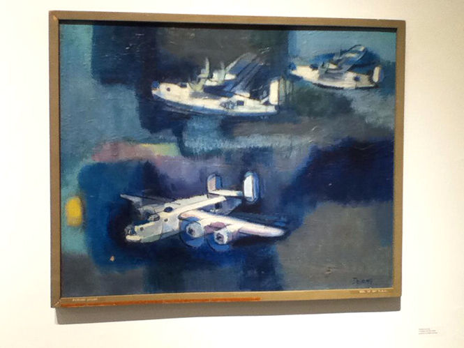  Freedom and the Artist by Patrick DeLong depicts World War II cargo planes. The painting belongs to the schools permanent collection.