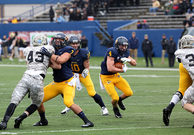 Sophomore running back Nick Holley runs the ball through Army defense during the Homecoming football game at Dix Stadium on October 18, 2014. The Flashes won, 39-17.