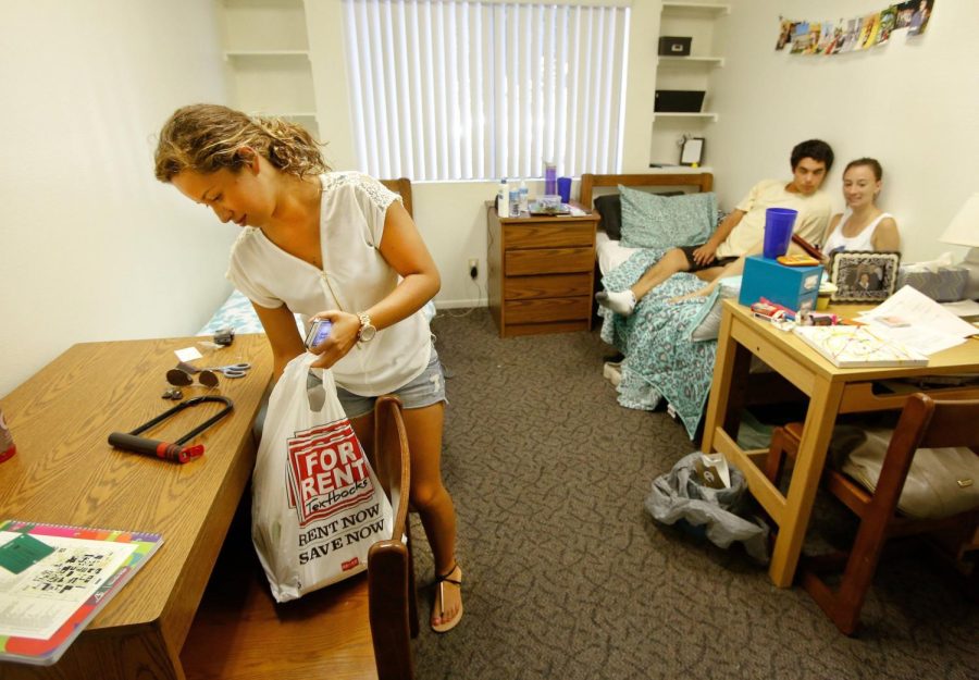 Carolina Saguero, 18, left, of South Los Angeles, a freshman at Cal State Northridge, is photographed inside her dorm room that she shares with Marlissa Frey, 18, right, of Santa Clarita, also a freshman, on August 26, 2013. Next to Frey is her friend Ricky Escalante, 18, who was visiting. 