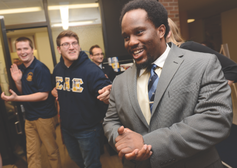 Senior entrepreneurship major Kevin Otubu reacts as he becomes the director of programming for Undergraduate Student Government as results of the elections are streamed in the Student Center on Tuesday, March 10, 2015.