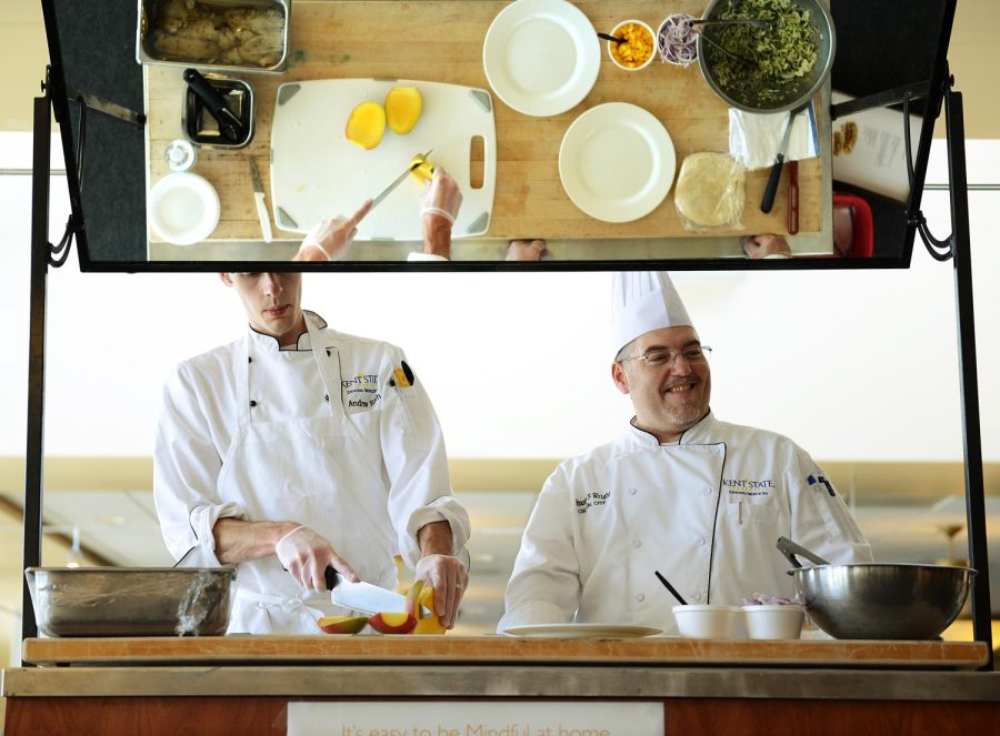 Chefs Andrew Eith and Timothy Wright prepare grilled fish tacos with mango slaw for a food demonstration introducing Kent States new mindful menu items. Photo courtesy of Kent State Dining Services.