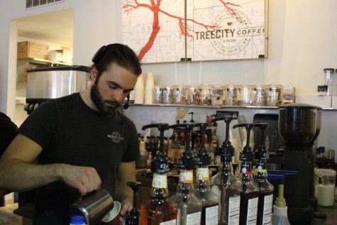 Employee Owen Park prepares a cup of coffee at Tree City in downtown Kent on April 7, 2014.