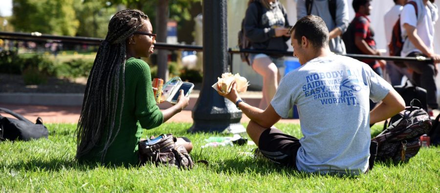 Tia Beaty, fashion merchandising freshman, and Austin Ward, applied communications junior, enjoy time on the green after Taste of Kent on Risman Plaza on Tuesday Sept 22, 2015.