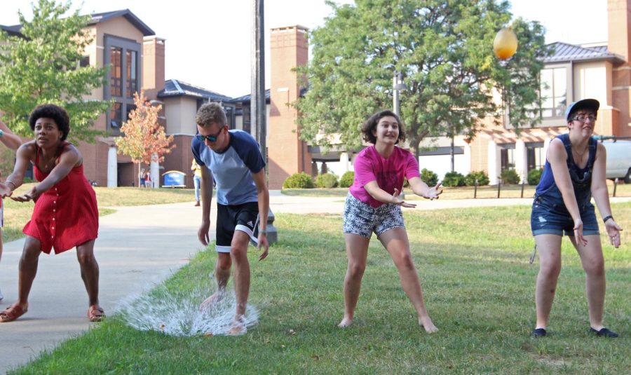 (From left) Junior communication studies major Alicia Johnson, sophomore public relations major Ian Gillan, freshman journalism major Carrie George and senior journalism major Blythe Alspaugh attempt to catch water balloons during a water balloon contest behind Olson Hall on Wednesday, Sept. 2, 2015.