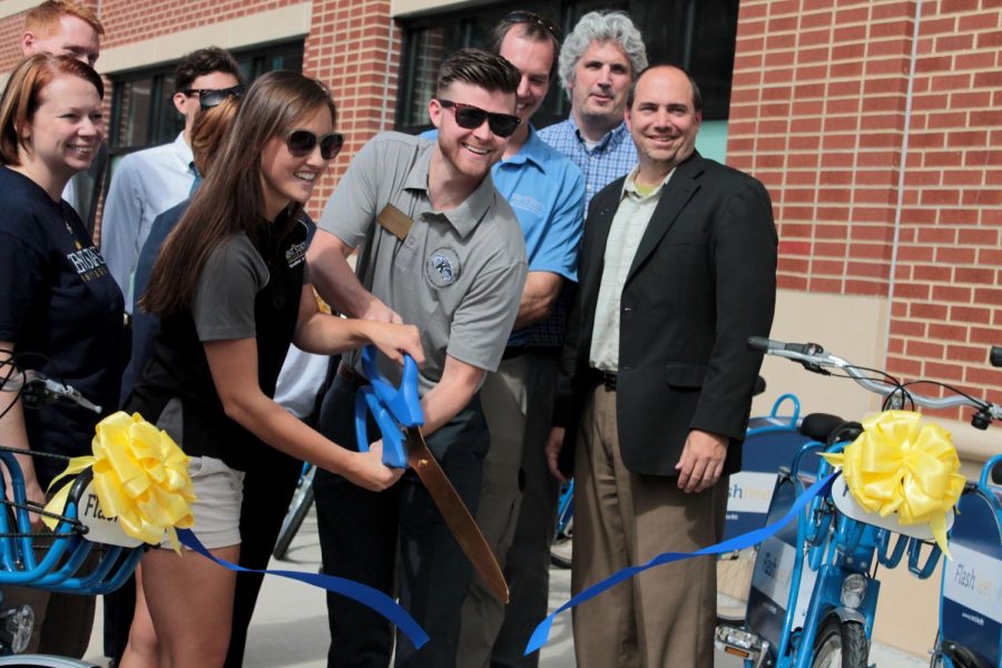 Brian Cannon, Executive Director of Undergraduate Student Government and Lauren Mazurkiewicz, Co-president of the Student Recreation Council cut the ribbon during the dediciation ceremoney of the new 3rd Generation Flash Fleet of bicycles avialable to rent by both Kent State students and residents of Kent on September 11, 2015.