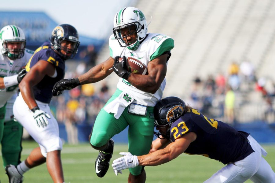 Tony Pittman (#23) of the Marshall Thundering Herd runs for a touchdown in the first quarter of Kent State vs Marshall game on Sept. 26, 2015. Kent State lost in double overtime, 36-29.