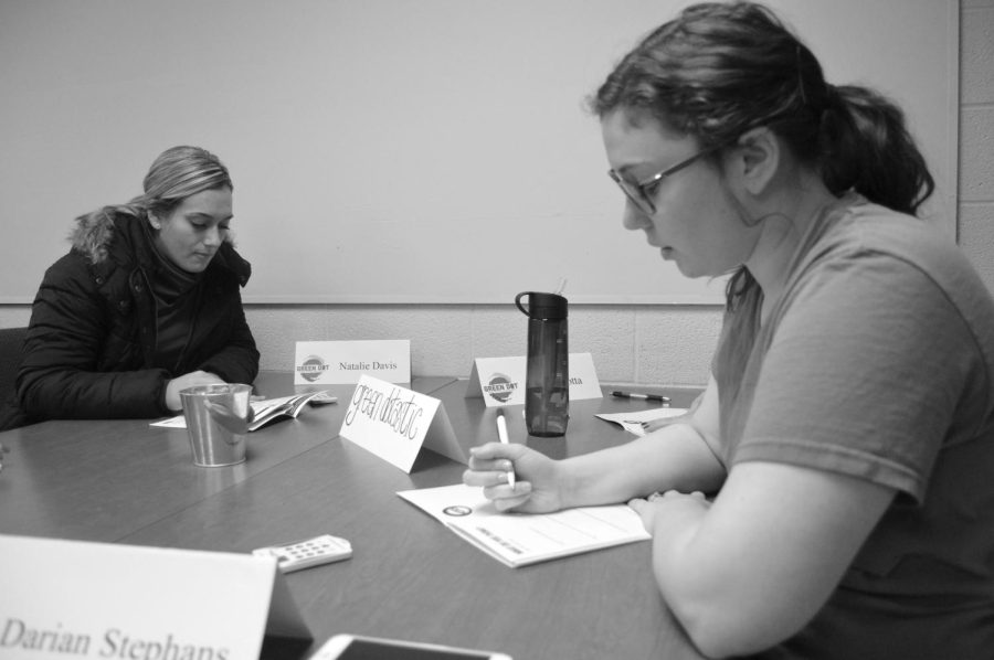 Natalie Davis (left) and Darian Stephens (right) discuss signs of stalking in their workbooks on March 5, 2015. Natalie and Darian along with their classmates are training to become Green Dot Certified.