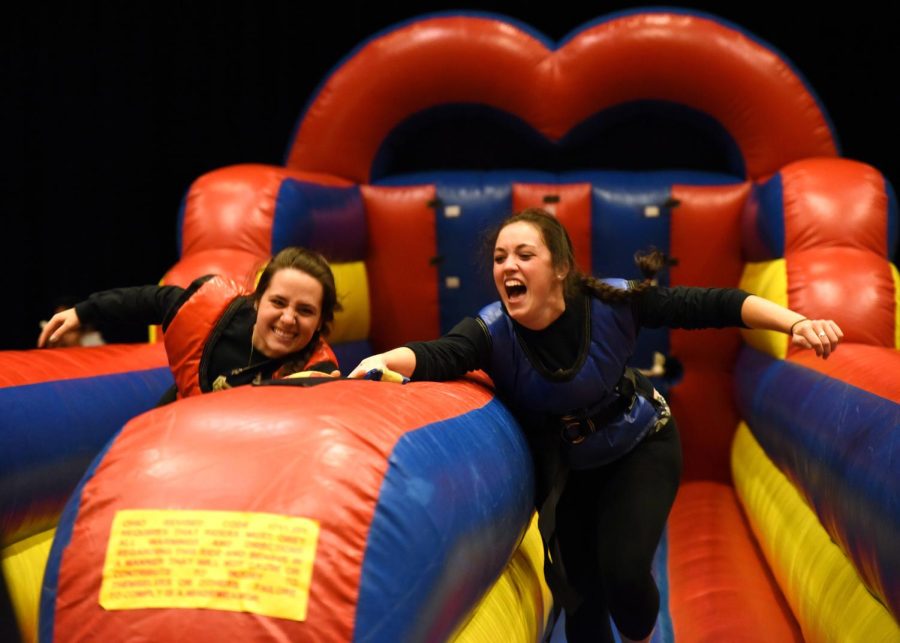 Elizabeth Bargdill (left), senior geology major, races against Emily Ancona (right), junior speech pathology major, in the Bungee Run at the Bounce Madness event held in the Student Center Ball Room on Wednesday night, Sept 30. 2015.
