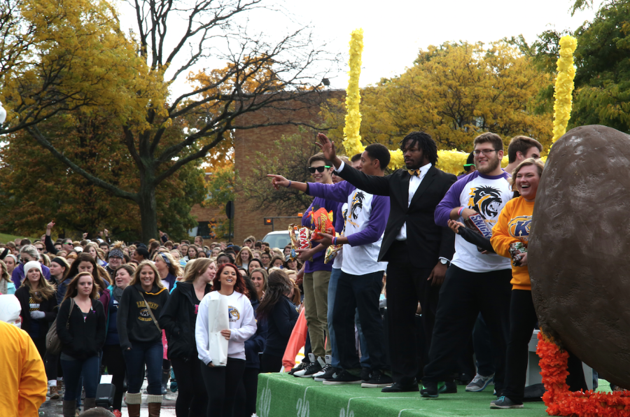Marvin Logan, former executive director of Undergraduate Student Government, and other USG members wave at onlookers during the Homecoming Parade on Oct. 18, 2014.