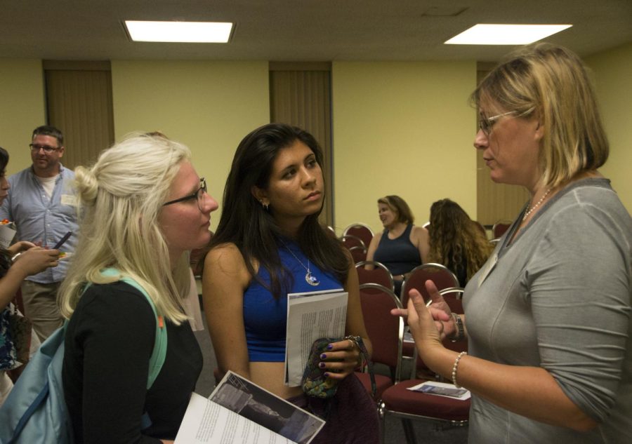 LGBT studies coordinator, Molly Merryman talks with students at the meeting for the emerging Center for the Study of Gender and Sexuality on Wednesday, Sept. 9, 2015.