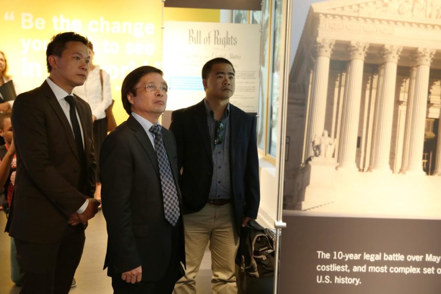 Members of the Hanoi University Delegation including President Nguyen Dinh Luan, Dean Dr. Hoang Gia Thu and Director of International Office Nguyen Ngoc Tan look at a display at the May 4th memorial museum in Taylor hall on Tuesday, Sept. 8, 2015. The trio are here to sign an agreement between the University of Hanoi and Kent State partnering them in a Student Exchange Program.