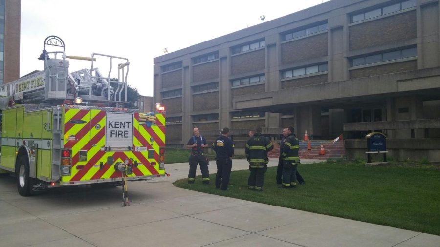 Kent Fire Department officers stand outside Williams Hall on Wednesday, Sept. 30, 2015. An intern accidentally started a small fire during an experiment, but the fire was extinguished quickly with no reported injuries.