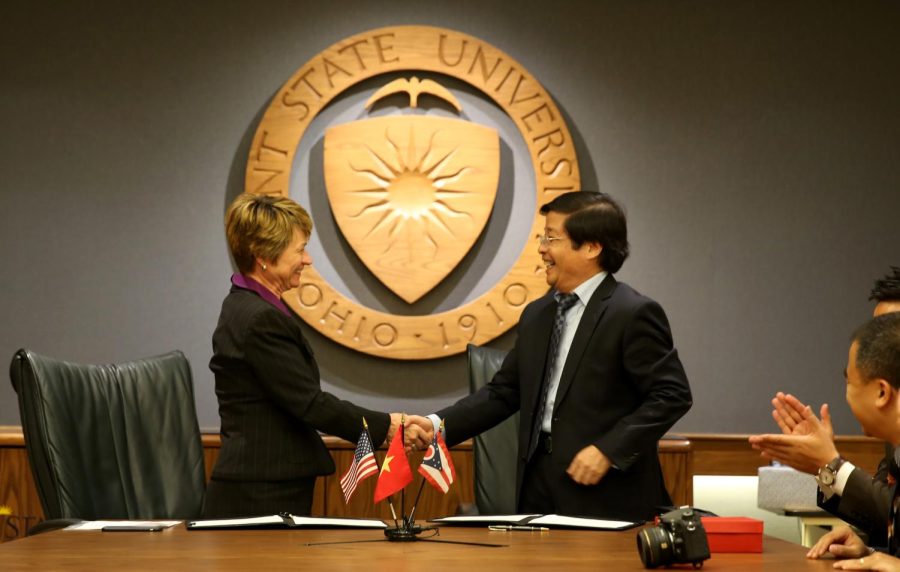 President of Hanoi University Nguyen Dinh Luan shakes hands with President Beverly Warren after singing a contract joining the two universities in an agreement that will allow for exchange students to go between the universities on Tuesday, Sept. 8, 2015.