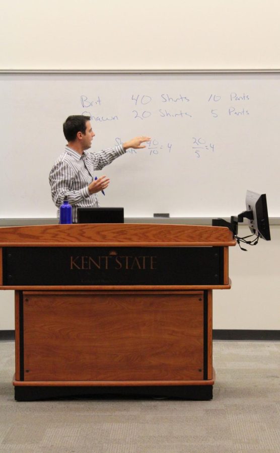 Shawn Rohlin, associate professor for economics, teaches his principles of microeconomics class on Wednesday, Sept. 23, 2015.