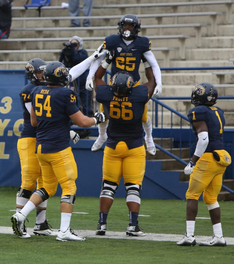 Junior Wide Receiver Ernest Calhoun gets hoisted over the head of Offensive lineman Anthony Pruitt after scoring a touchdown against Miami University. The Flashes beat Miami at Dix Stadium for the homecoming game 20-14.
