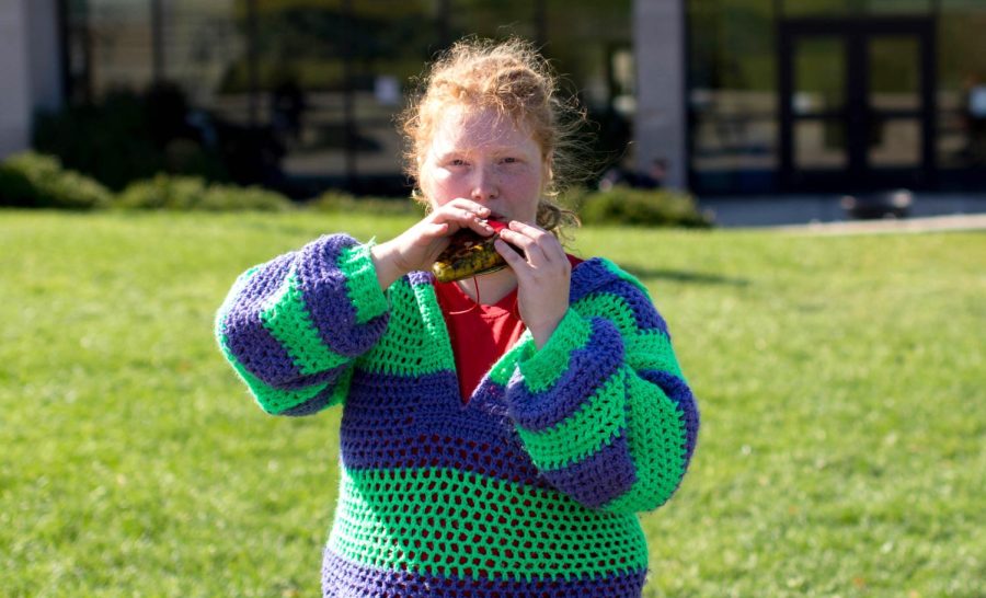 Kayla Henry plays the ocarina flute on the Esplanade outside of Bowman Hall on Tuesday Oct. 20, 2015.