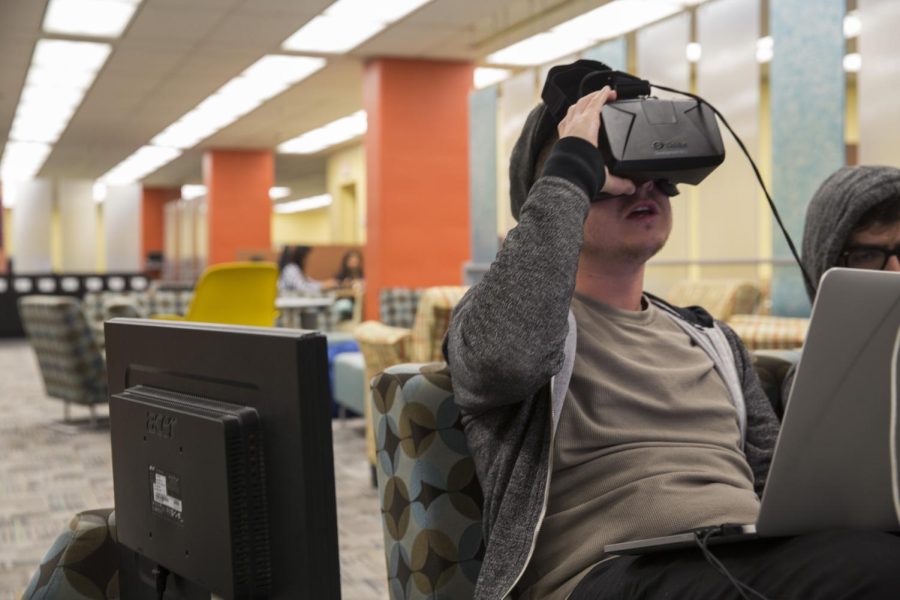 Senior computer science major Kyle McMaster tests his work with his Oculus virtual reality goggles during Kent Hack Enough on Saturday, Oct. 10, 2015.
