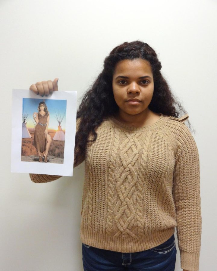 President of the Native American Student Association, Chelsea Ford, holds up a picture of a “Native American costume. 