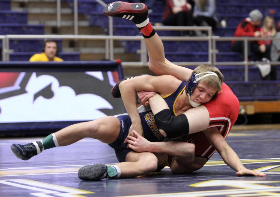 Kent State’s Mack McGuire tries to escape the hold of Northern Illinois’ Jordan Northrup during their meet in the M.A.C. Center on Friday, Feb. 13, 2015.
