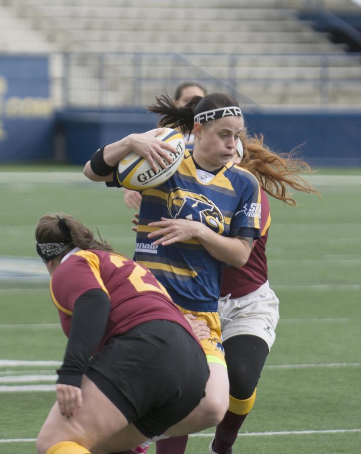 Sophomore+Holly+Chesnick+tries+breaking+free+with+the+ball+during+the+Kent+State+womens+rugby+game+against+Central+Michigan+at+Dix+Stadium+on+Saturday%2C+Oct.+17%2C+2015.+Kent+state+won+big+against+Central+Michigan+with+a+final+score+of+81-10.