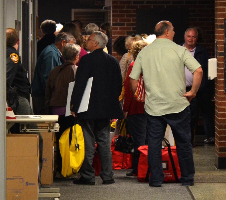 Poll workers arrived at the Portage Board of Elections office in Ravenna on Tuesday night, October 3, 2015, after polls had closed. The poll workers organized the ballots before bringing them to the election office.