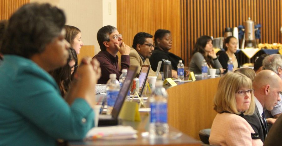 Guests and members of the Kent State Faculty Senate listen and wait to hear their name during roll call on Monday, Nov. 9, 2015.