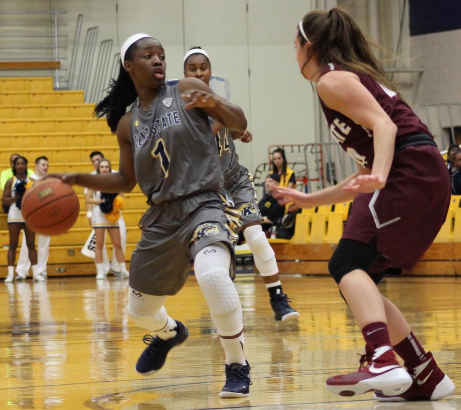 Sophomore gaurd Naddiyah Cross protects the ball from a player on Colgate Universitys team during the womens basketball game at the MACC. The Flashes won the game 76-71. Nov. 15, 2015.